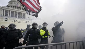 Police hold off Trump supporters who tried to break through a police barrier, Wednesday, Jan. 6, 2021, at the Capitol in Washington. As Congress prepares to affirm President-elect Joe Biden&#39;s victory, thousands of people have gathered to show their support for President Donald Trump and his claims of election fraud. (AP Photo/Julio Cortez)