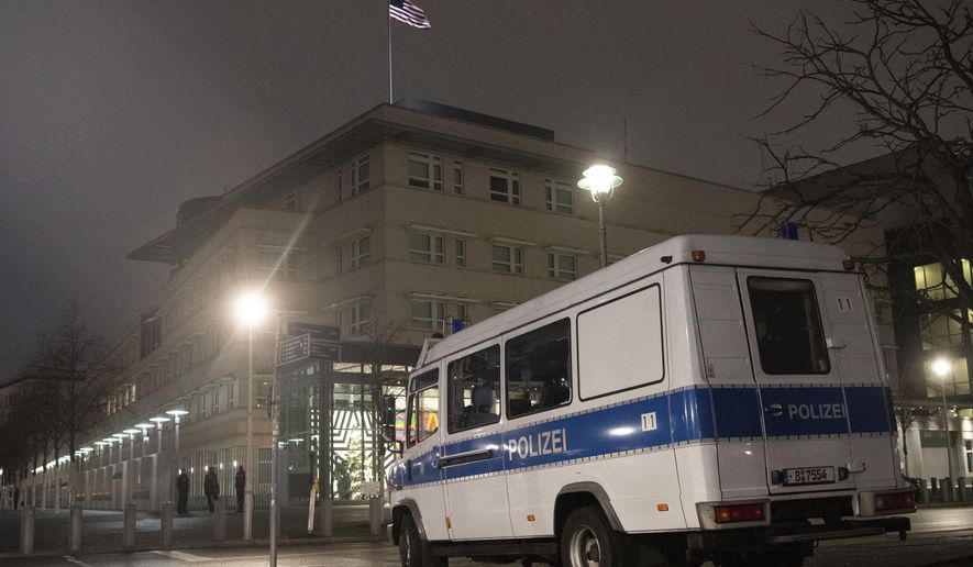 A police emergency vehicle is parked at the U.S. embassy in Berlin Thursday, Jan. 7, 2021. After a violent mob in Washington, security around the embassy building was increased. (Paul Zinken/dpa via AP)
