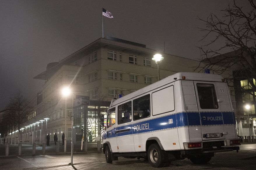 A police emergency vehicle is parked at the U.S. embassy in Berlin Thursday, Jan. 7, 2021. After a violent mob in Washington, security around the embassy building was increased. (Paul Zinken/dpa via AP)