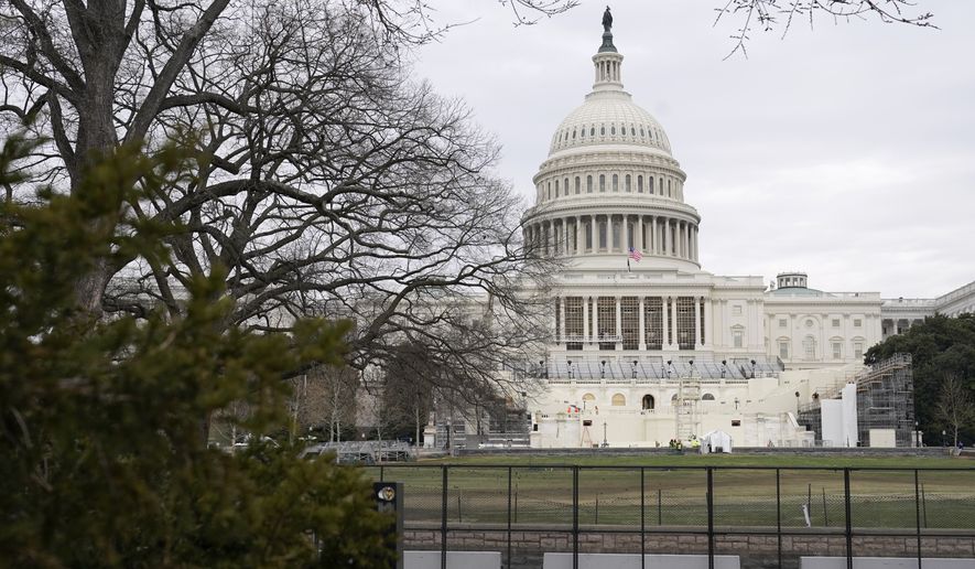 Preparations take place for President-elect Joe Biden&#39;s inauguration behind security fencing protecting the West Front of the U.S. Capitol in Washington, Friday, Jan. 8, 2021, after supporters of President Donald Trump stormed the building. (AP Photo/Patrick Semansky)