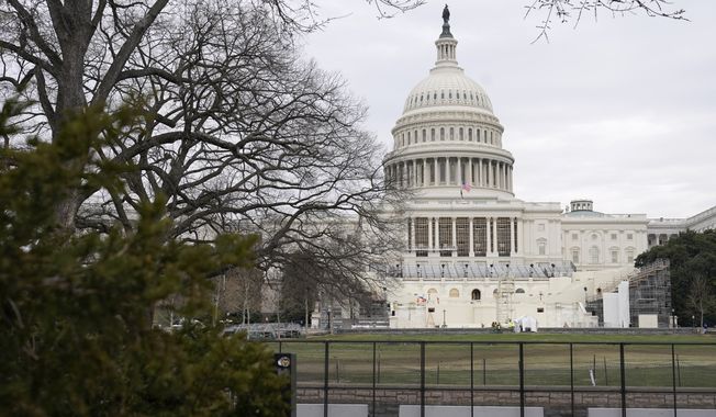Preparations take place for President-elect Joe Biden&#x27;s inauguration behind security fencing protecting the West Front of the U.S. Capitol in Washington, Friday, Jan. 8, 2021, after supporters of President Donald Trump stormed the building. (AP Photo/Patrick Semansky)