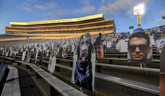 FILE - In this Oct. 31, 2020, file photo, cardboard cutouts of fans sit in the south stands before an NCAA college football game between Penn State and Ohio State in State College, Pa. In 2021, college football will attempt to return to normal after a season roiled by the pandemic while also adapting to a new paradigm in which the athletes have more power than ever before. (AP Photo/Barry Reeger, File)