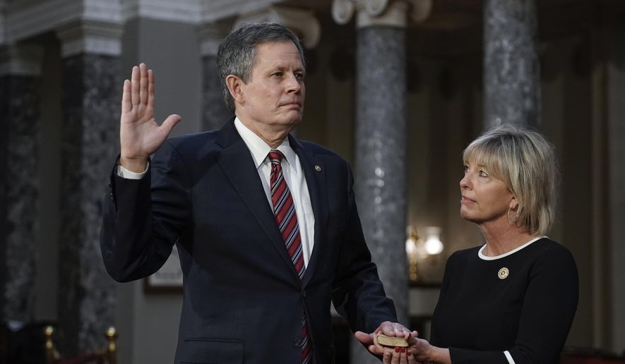 FILE - In this Jan. 3, 2021, file photo, Sen. Steve Daines, R-Mont., joined by his wife Cindy Daines, raises his hand to take the oath of office from Vice President Mike Pence during a reenactment ceremony in the Old Senate Chamber at the Capitol in Washington. After months of tacitly or directly supporting President Donald Trump&#39;s denial of the results of the 2020 election, top Montana Republicans denounced the violence that took over the nation&#39;s Capitol and delayed Congress&#39; certification of the presidential election for Joe Biden. But one of them doubled down. (AP Photo/J. Scott Applewhite, Pool, File)