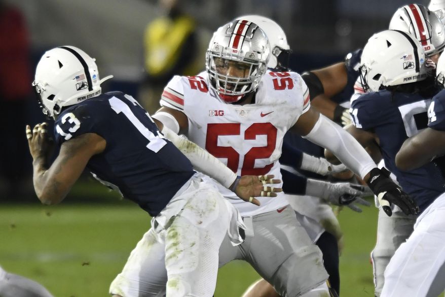 FILE - In this Oct. 31, 2020, file photo, Ohio State offensive lineman Wyatt Davis (52) looks to block Penn State linebacker Ellis Brooks (13) during an NCAA college football game in State College, Pa. Davis is likely to face his biggest challenge of the year when Ohio State meets Alabama in the national championship game on Monday, Jan. 11, 2021. (AP Photo/Barry Reeger, File)