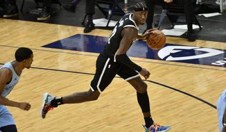 Brooklyn Nets guard Caris LeVert (22) brings the ball upcourt in the second half of an NBA basketball game against the Memphis Grizzlies, Friday, Jan. 8, 2021, in Memphis, Tenn. (AP Photo/Brandon Dill)