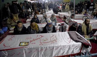 People from the Shiite Hazara community gather around coffins of coal mine workers killed by gunmen near the Machh coal field, during a sit-in to protest, in Quetta, Pakistan, Friday, Jan. 8, 2021. Pakistan&#39;s prime minister Friday appealed the protesting minority Shiites not to link the burial of 11 coal miners from Hazara community who were killed by the Islamic State group to his visit to the mourners, saying such a demand amounted to blackmailing the country&#39;s premier. (AP Photo/Arshad Butt)