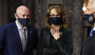 Sen. Mark Kelly, D-Ariz., talks with his wife former Rep. Gabby Giffords, D-Ariz., and Vice President Mike Pence after participating in a re-enactment of his swearing-in Wednesday, Dec. 2, 2020, on Capitol Hill in Washington. (Nicholas Kamm/Pool via AP)
