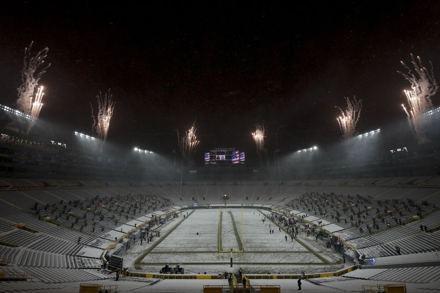 The seats in the end zone are empty at Lambeau Field during the national anthem before an NFL football game between the Green Bay Packers and the Tennessee Titans Sunday, Dec. 27, 2020, in Green Bay, Wis. (AP Photo/Morry Gash)