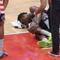 Washington Wizards center Thomas Bryant (13) lies injured on the court during the first half of an NBA basketball game against the Miami Heat, Saturday, Jan. 9, 2021, in Washington. (AP Photo/Nick Wass)  **FILE**