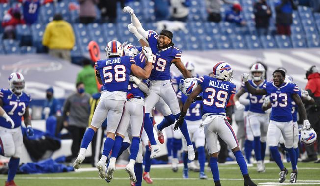 Buffalo Bills&#x27; Matt Milano (58) and Josh Norman (29) and teammates celebrate after an NFL wild-card playoff football game against the Indianapolis Colts Saturday, Jan. 9, 2021, in Orchard Park, N.Y. The Bills won the game 27-24. (AP Photo/Adrian Kraus)