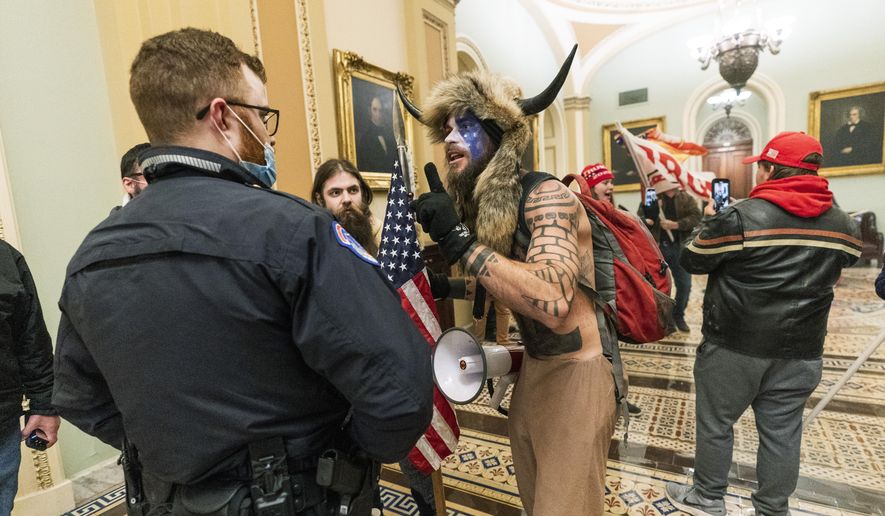 Rioters are confronted by U.S. Capitol Police officers outside the Senate Chamber inside the Capitol in Washington, Jan. 6, 2021. (AP Photo/Manuel Balce Ceneta, File)  **FILE**