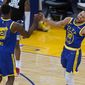 Golden State Warriors forward Andrew Wiggins (22) celebrates with guard Stephen Curry (30) after Wiggins made a 3-point shot against the Los Angeles Clippers during the second half of an NBA basketball game in San Francisco, Friday, Jan. 8, 2021. (AP Photo/Tony Avelar)