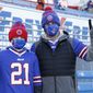 Buffalo Bills fans Scott Hammond, right, and his son Landon pose for a photograph as their team warms up before an NFL wild-card playoff football game against the Indianapolis Colts, Saturday, Jan. 9, 2021, in Orchard Park, N.Y. The Hammonds were among the lucky 6,700 few to land tickets for the Bills wild-card playoff against the Indianapolis Colts for Buffalo&#39;s first home playoff game in 24 years. (AP Photo/Jeffrey T. Barnes)