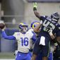 Seattle Seahawks defensive end Carlos Dunlap (43) leaps to try and deflect a pass from Los Angeles Rams quarterback Jared Goff during the second half of an NFL wild-card playoff football game, Saturday, Jan. 9, 2021, in Seattle. (AP Photo/Scott Eklund)