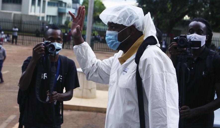 Zimbabwean journalist Hopwell Chin'ono arrives at the magistrates courts in Harare, Saturday, Jan. 9, 2021. On Friday, Zimbabwe police arrested the prominent journalist for the third time in six months. Chin’ono posted on his Twitter account that police had picked him from his house and said they were charging him with “communicating falsehoods.” (AP Photo/Tsvangirayi Mukwazhi)