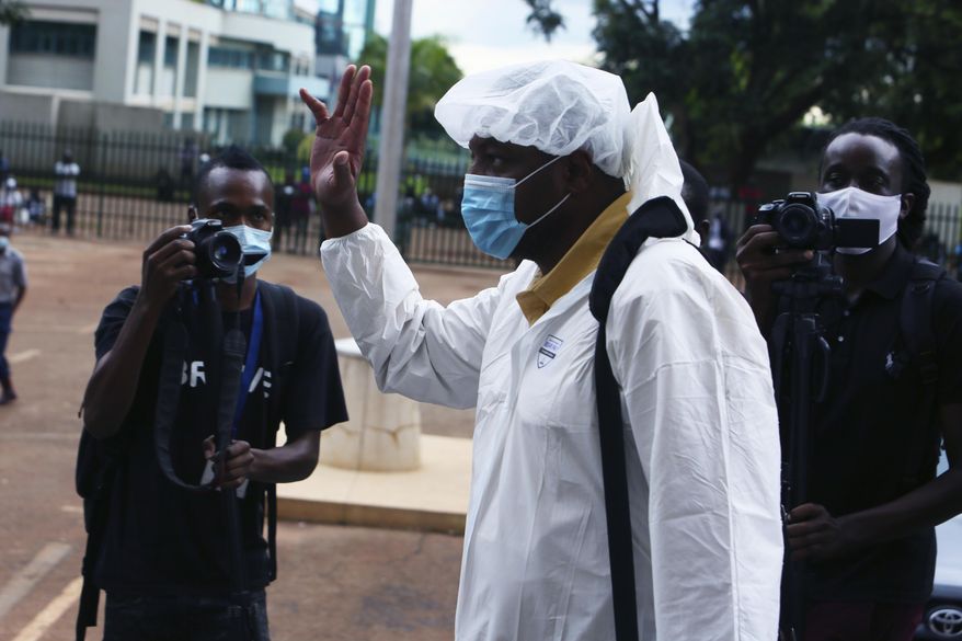 Zimbabwean journalist Hopwell Chin'ono arrives at the magistrates courts in Harare, Saturday, Jan. 9, 2021. On Friday, Zimbabwe police arrested the prominent journalist for the third time in six months. Chin’ono posted on his Twitter account that police had picked him from his house and said they were charging him with “communicating falsehoods.” (AP Photo/Tsvangirayi Mukwazhi)