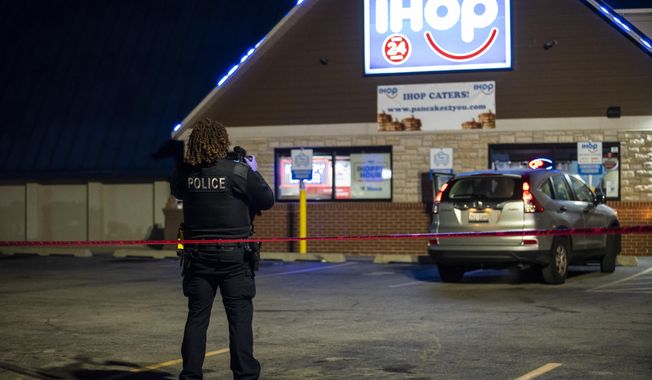 Chicago and Evanston police investigate the scene of a shooting outside an IHOP restaurant in Evanston, Ill., Saturday night, Jan. 9, 2020. (Ashlee Rezin Garcia/Chicago Sun-Times via AP)