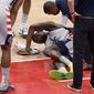 Washington Wizards center Thomas Bryant, center, lies injured on the court during the first half of an NBA basketball game against the Miami Heat, Saturday, Jan. 9, 2021, in Washington. (AP Photo/Nick Wass)