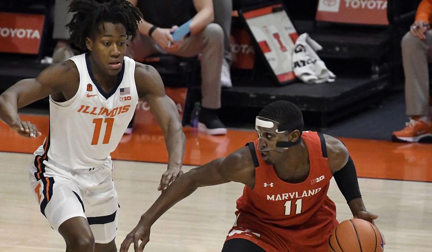 Maryland&#39;s guard Darryl Morsell (11) is pressured by Illinois guard Ayo Dosunmu (11) in the first half of an NCAA college basketball game Sunday, Jan. 10, 2021, in Champaign, Ill. (AP Photo/Holly Hart)