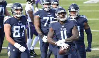 Tennessee Titans wide receiver A.J. Brown (11) celebrates after making a touchdown catch against the Baltimore Ravens in the first half of an NFL wild-card playoff football game Sunday, Jan. 10, 2021, in Nashville, Tenn. (AP Photo/Mark Zaleski)