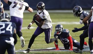 Baltimore Ravens quarterback Lamar Jackson (8) scrambles against the Tennessee Titans in the second half of an NFL wild-card playoff football game Sunday, Jan. 10, 2021, in Nashville, Tenn. (AP Photo/Wade Payne)