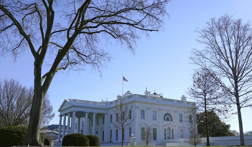 An American flag flies above the White House in Washington, Sunday, Jan. 10, 2021. (AP Photo/Patrick Semansky)