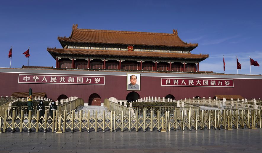 Chinese paramilitary policemen wearing face masks to help curb the spread of the coronavirus stand guard at the quiet Tiananmen Gate in Beijing, Sunday, Jan. 10, 2021. More than 360 people have tested positive in a growing COVID-19 outbreak south of Beijing in neighboring Hebei province. (AP Photo/Andy Wong)
