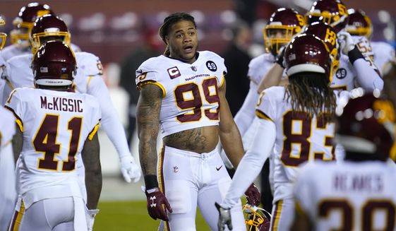 Washington Football Team defensive end Chase Young (99) looks on prior to an NFL wild-card playoff football game against the Tampa Bay Buccaneers, Saturday, Jan. 9, 2021, in Landover, Md. Tampa Bay won 31-23. (AP Photo/Julio Cortez)