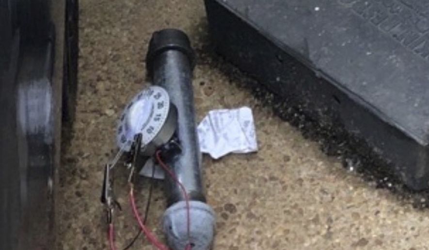An explosive device is shown outside of the Republican National Committee office, Wednesday, Jan. 6, 2021 in Washington. As thousands of supporters of President Donald Trump stormed the U.S. Capitol on Wednesday, federal agents were working at the same time to detonate this pipe bomb and another, found just blocks away at the offices of the Republican and Democratic National Committees. (AP Photo)