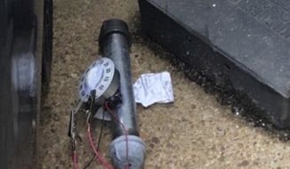 An explosive device is shown outside of the Republican National Committee office, Wednesday, Jan. 6, 2021 in Washington. As thousands of supporters of President Donald Trump stormed the U.S. Capitol on Wednesday, federal agents were working at the same time to detonate this pipe bomb and another, found just blocks away at the offices of the Republican and Democratic National Committees. (AP Photo)