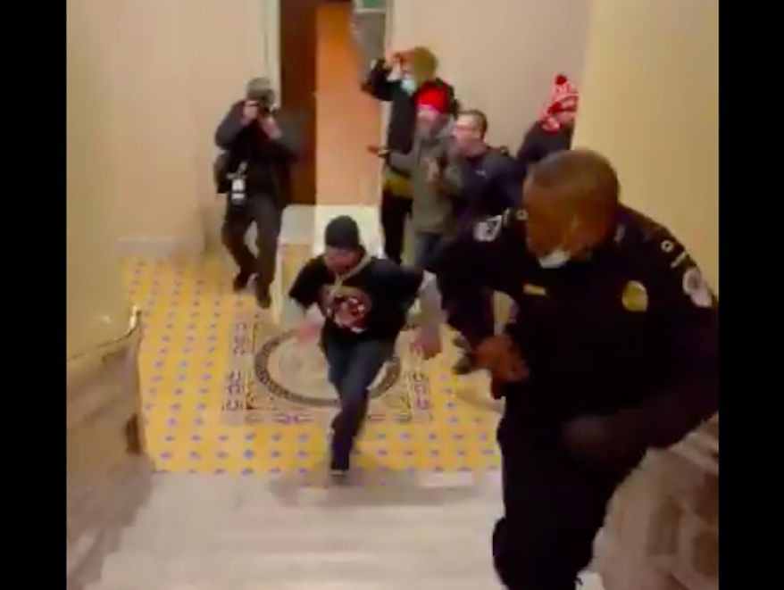 Capitol Police officer Eugene Goodman is being hailed a hero after a now-viral video showed him luring an angry mob of Trump supporters away from the Senate floor during Wednesday's violent insurrection at the U.S. Capitol. (Screengrab via Twitter/@igorbobic)