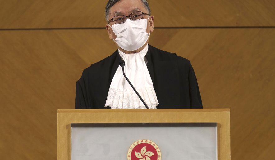 New Hong Kong Chief Justice Andrew Cheung listens to reporters questions during a press conference in Hong Kong Monday, Jan. 11, 2021. Hong Kong’s new top judge warned Monday that the semiautonomous Chinese territory’s courts need to show they are impartial amid a flurry of politically charged cases or risk losing public trust. (AP Photo/Vincent Yu)