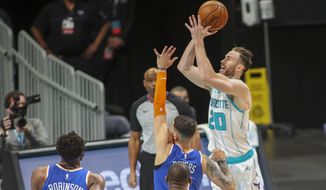 Charlotte Hornets forward Gordon Hayward (20) shoots over New York Knicks guard Austin Rivers in the first quarter of an NBA basketball game in Charlotte, N.C., Monday, Jan. 11, 2021. (AP Photo/Nell Redmond)
