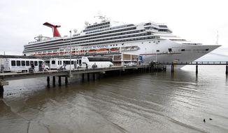 FILE - Passengers disembark from the Carnival Sunshine cruise ship Monday, March 16, 2020, in Charleston, S.C. Carnival Corp. said Monday, Jan. 11, 2021 its 2022 cruise bookings are running ahead of 2019 numbers, a good sign that guests will return once the pandemic has eased. The coronavirus has been devastating for the cruise industry, which had expected to welcome 30 million passengers worldwide in 2020. (AP Photo/Mic Smith, file)