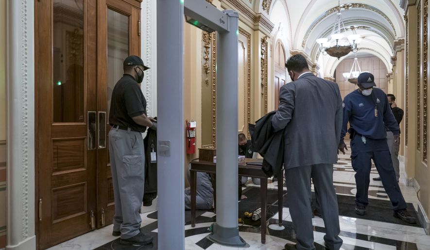 Metal detectors for lawmakers are installed in the corridor around the House of Representatives chamber after a mob loyal to President Donald Trump stormed the Capitol last week, in Washington, Tuesday, Jan. 12, 2021. (AP Photo/J. Scott Applewhite)