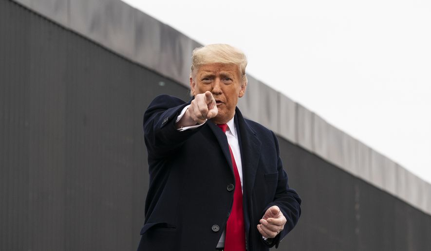 President Donald Trump points to a member of the audience after speaking near a section of the U.S.-Mexico border wall, Tuesday, Jan. 12, 2021, in Alamo, Texas. (AP Photo/Alex Brandon) **FILE**