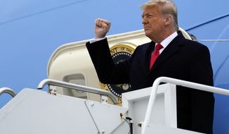 President Donald Trump gestures as he steps off Air Force One upon arrival at Valley International Airport, Tuesday, Jan. 12, 2021, in Harlingen, Texas. (AP Photo/Alex Brandon)
