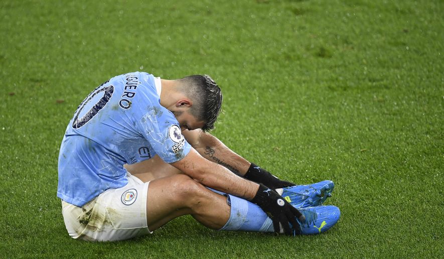 Manchester City's Sergio Aguero after taking a tumble during the English Premier League soccer match between Manchester City and Newcastle United at the Etihad stadium in Manchester, Saturday, Dec. 26, 2020. (Peter Powell/Pool via AP)