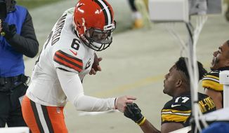 Cleveland Browns quarterback Baker Mayfield (6) greets Pittsburgh Steelers wide receiver JuJu Smith-Schuster (19) after defeating them in an NFL wild-card playoff football game, late Sunday, Jan. 10, 2021, in Pittsburgh. (AP Photo/Keith Srakocic)