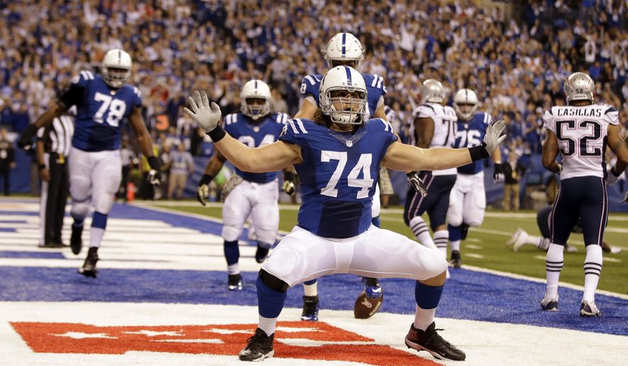 FILE - Indianapolis Colts tackle Anthony Castonzo celebrates after making a catch for a touchdown against the New England Patriots during the second half of an NFL football game in Indianapolis, in this Sunday, Nov. 16, 2014, file photo. Catsonzo, the Colts longtime left tackle, announced his retirement Tuesday, Jan. 12, 2021. The 32-year-old had been an anchor on Indy&#x27;s offensive line since he was the No. 22 overall draft pick in 2011. (AP Photo/Darron Cummings, File)