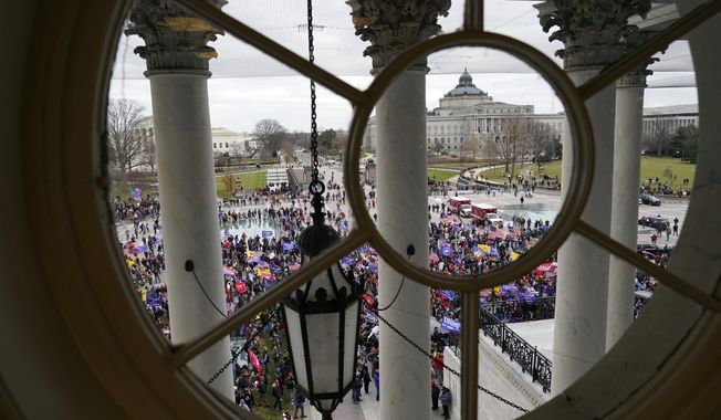 Violent protesters gather outside the U.S. Capitol, Wednesday, Jan 6, 2021. (AP Photo/Andrew Harnik)