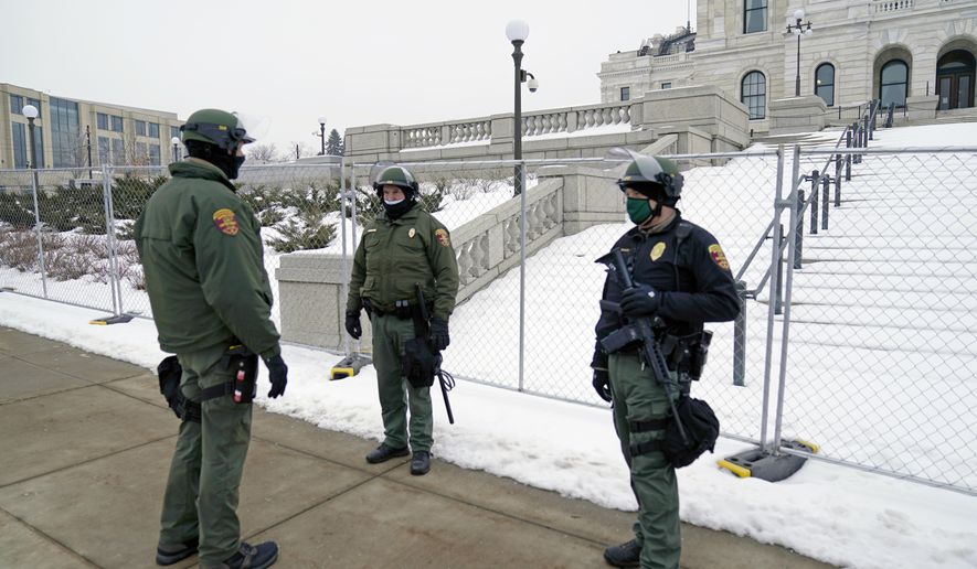 Minnesota Law Enforcement officers protect the Minnesota State Capitol Thursday, Jan. 7, 2021 in St. Paul, Minn., in the wake of the Electoral College protests Wednesday at the U.S. Capitol in Washington, D.C. (AP Photo/Jim Mone)