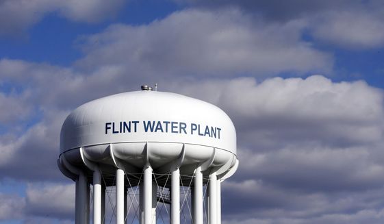 FILE - In this March 21, 2016, file photo, the Flint Water Plant water tower is seen in Flint, Mich. Former Michigan Gov. Rick Snyder, Nick Lyon, former director of the Michigan Department of Health and Human Services, and other ex-officials have been told they&#39;re being charged after a new investigation of the Flint water scandal, which devastated the majority Black city with lead-contaminated water and was blamed for a deadly outbreak of Legionnaires&#39; disease in 2014-15, The Associated Press has learned. (AP Photo/Carlos Osorio, File)