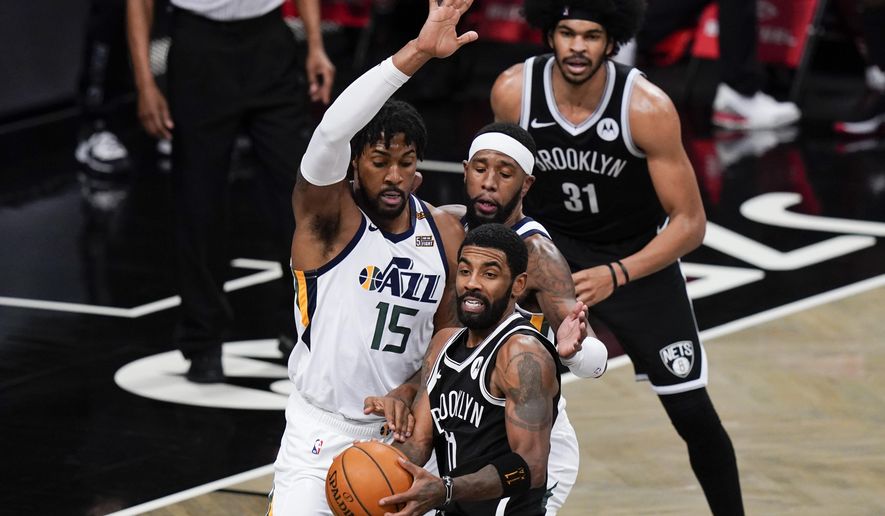 Utah Jazz&#39;s Derrick Favors (15) defens Brooklyn Nets&#39; Kyrie Irving (11) during the second half of an NBA basketball game Tuesday, Jan. 5, 2021, in New York. (AP Photo/Frank Franklin II)