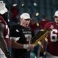 Alabama quarterback Mac Jones, middle, offensive linemen Alex Leatherwood, left, and Landon Dickerson, right, celebrate with the trophy, after their win against Ohio State in an NCAA College Football Playoff national championship game, Tuesday, Jan. 12, 2021, in Miami Gardens, Fla. Alabama won 52-24. (AP Photo/Chris O&#39;Meara)