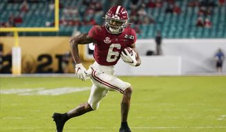 Alabama wide receiver DeVonta Smith runs for a touchdown against Ohio State during the first half of an NCAA College Football Playoff national championship game, Monday, Jan. 11, 2021, in Miami Gardens, Fla. (AP Photo/Chris O&#39;Meara) **FILE**