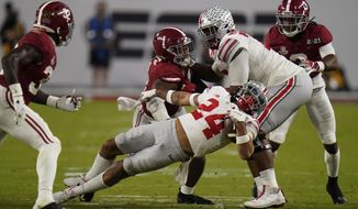 Ohio State running back Marcus Crowley is tackled by Alabama during the second half of an NCAA College Football Playoff national championship game, Monday, Jan. 11, 2021, in Miami Gardens, Fla. (AP Photo/Chris O&#x27;Meara)