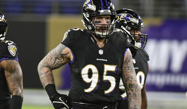 Baltimore Ravens defensive end Derek Wolfe (95) looks on during the first half of an NFL football game against the Dallas Cowboys, Tuesday, Dec. 8, 2020, in Baltimore. Wolfe, an energetic and talented defensive end, lost his passion for the game during a miserable four-year stretch in Denver that featured three head coaches, 37 defeats and not a single trip to the postseason. So he took a one-year deal with Baltimore, and now Wolfe and the Ravens are right where they want to be in the middle of January: still alive in the playoffs and very much in the running for a trip to the Super Bowl. (AP Photo/Terrance Williams, File)