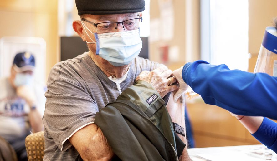 Jim Clark, 86, receives a first dose of Pfizer-BioNTech COVID-19 vaccine from UC Davis Health on Tuesday, Jan. 12, 2021, in Sacramento, Calif. (AP Photo/Noah Berger, Pool)