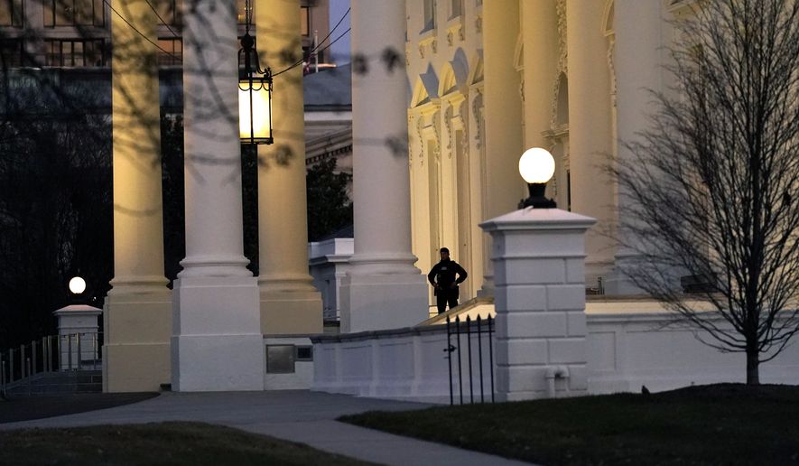 A U.S. Secret Service guard stands post at the North Portico of the White House, after the U.S. House impeached President Donald Trump in Washington, Wednesday, Jan. 13, 2021. (AP Photo/Gerald Herbert )